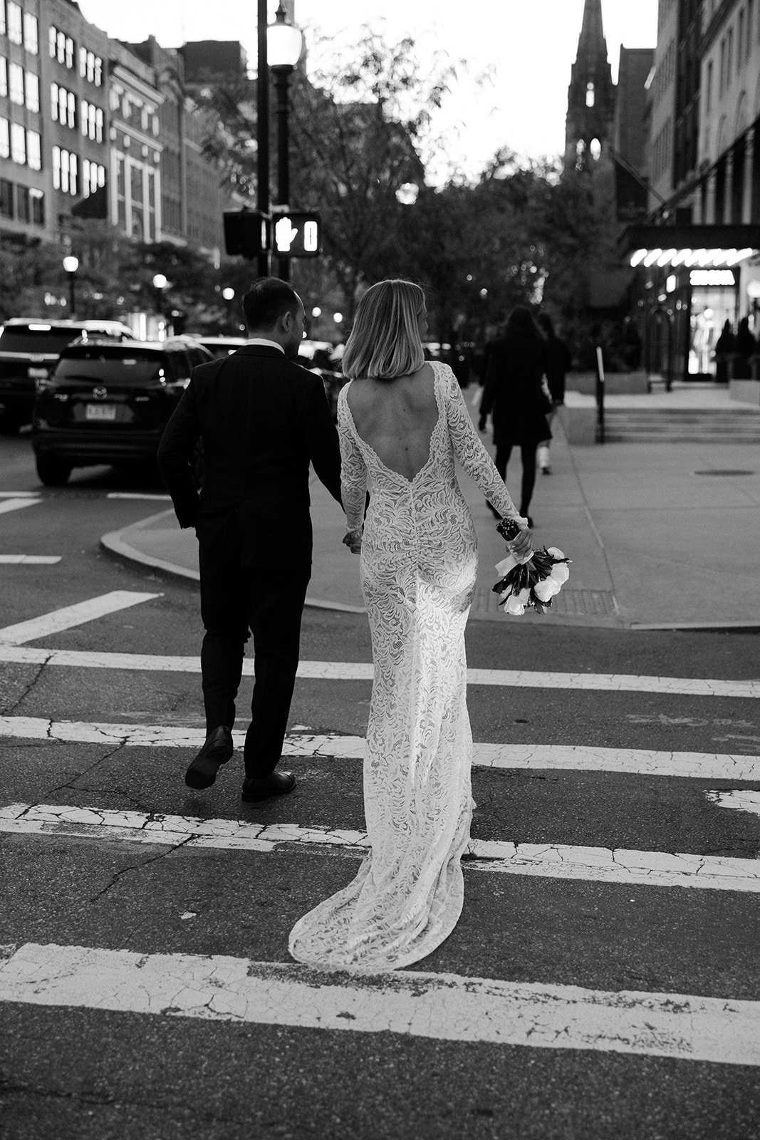 A bride and groom on the street after their boston elopement