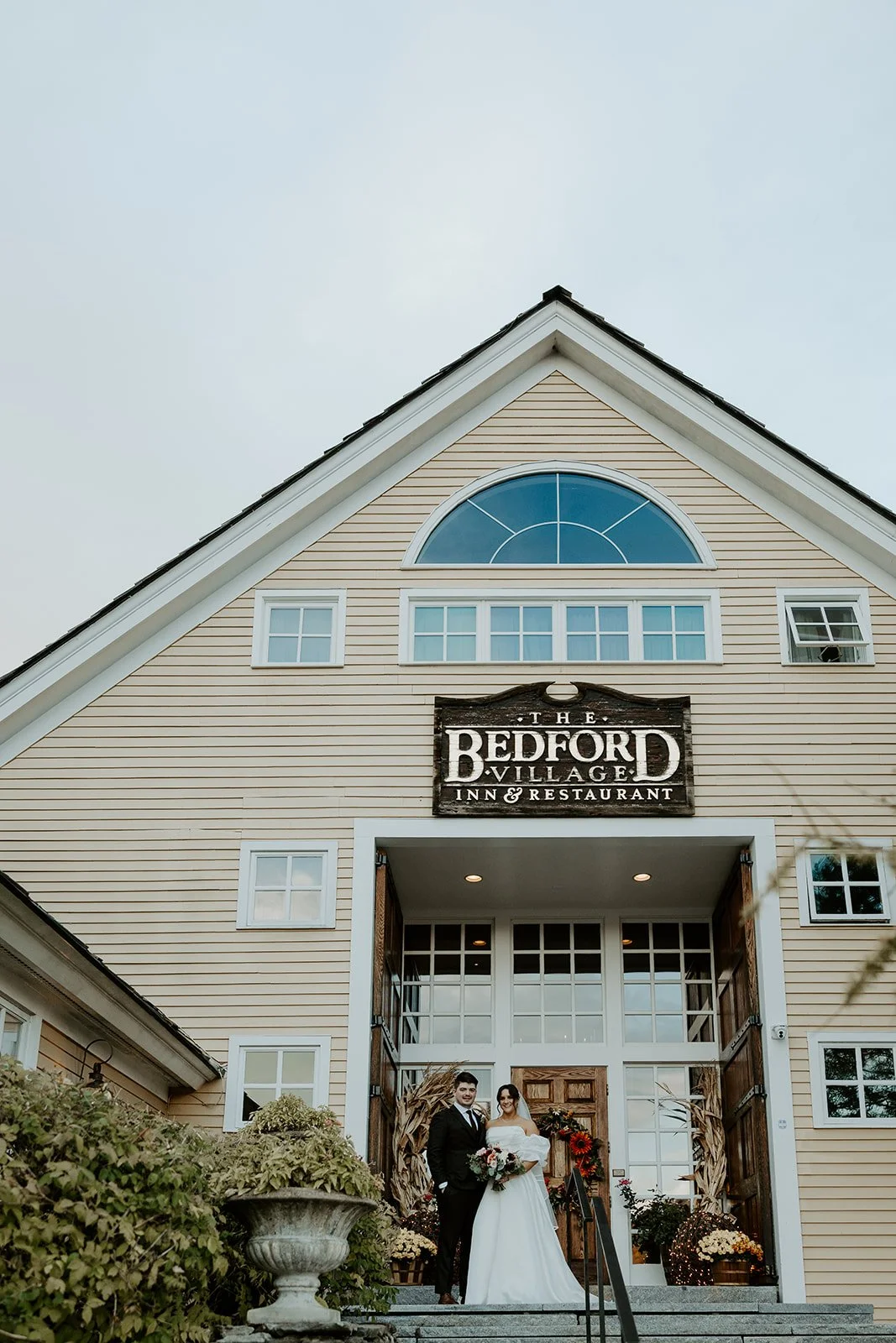 A bride and groom posing at their new hampshire wedding venue, Bedford Village inn