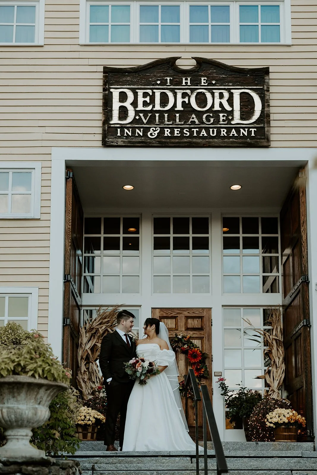 A bride and groom posing at their new hampshire wedding venue, Bedford Village inn