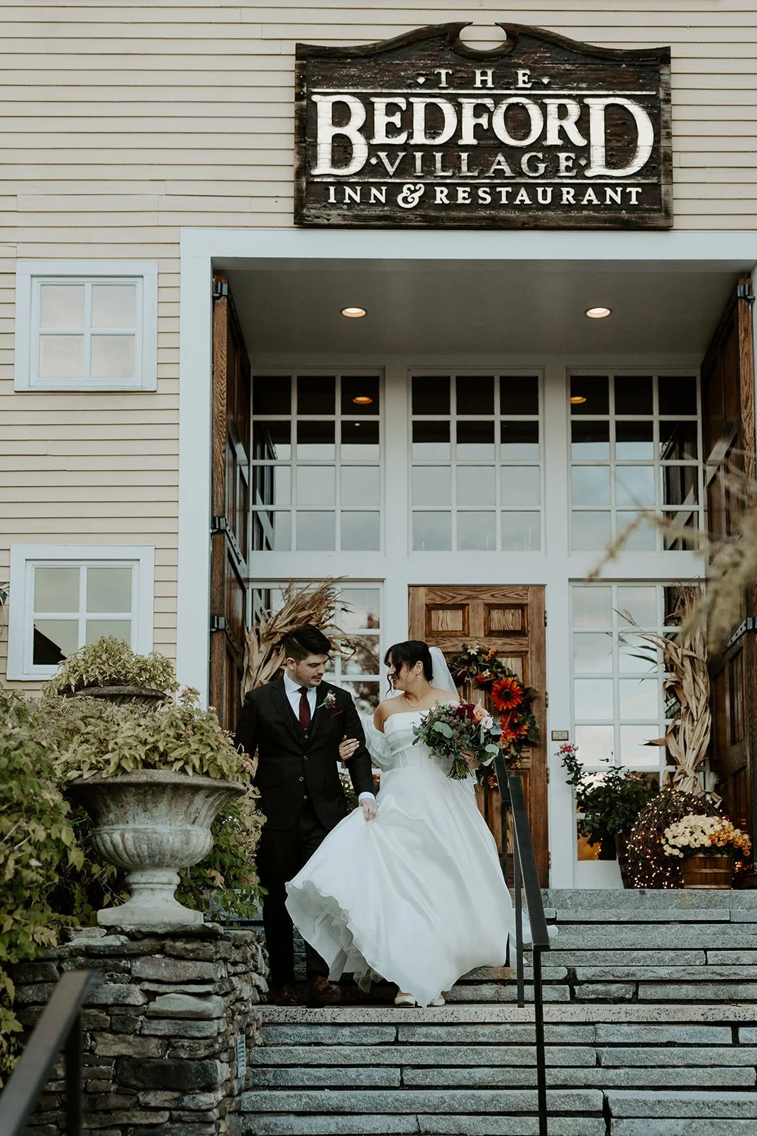 A bride and groom posing at their new hampshire wedding venue, Bedford Village inn