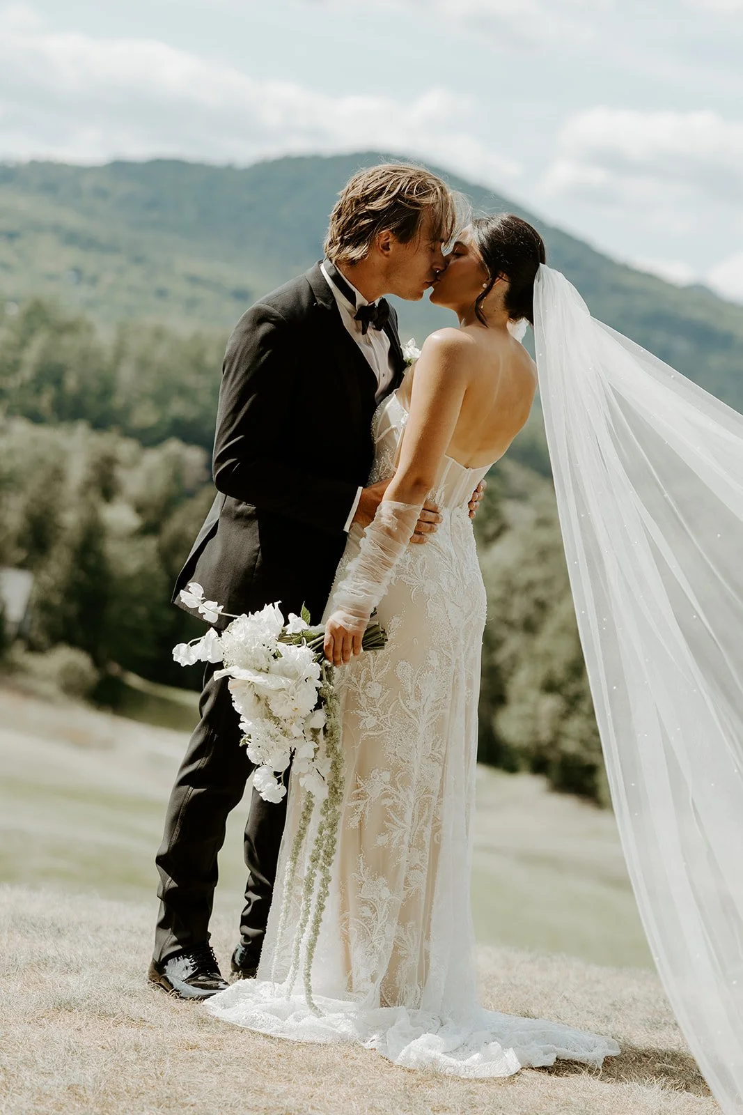 A bride and groom posing for photos at new hampshire wedding venue owls nest resort