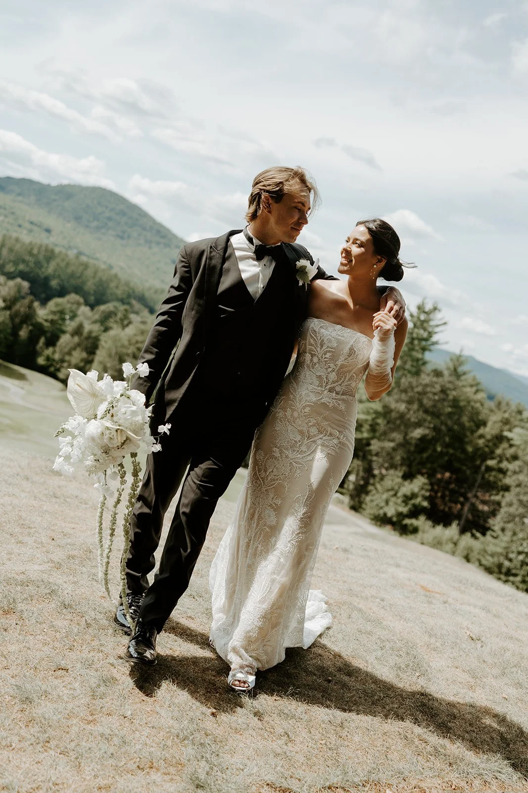 A bride and groom posing for photos at new hampshire wedding venue owls nest resort
