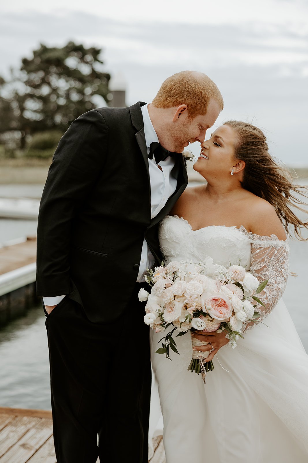 A couple taking coastal wedding photos at their new hampshire wedding venue