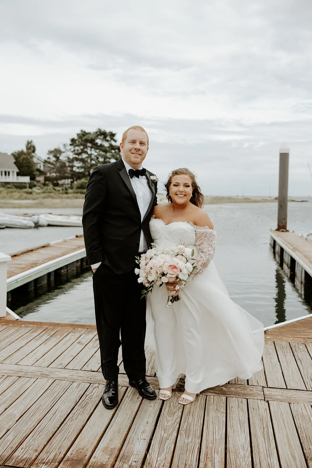 A couple taking coastal wedding photos at their new hampshire wedding venue