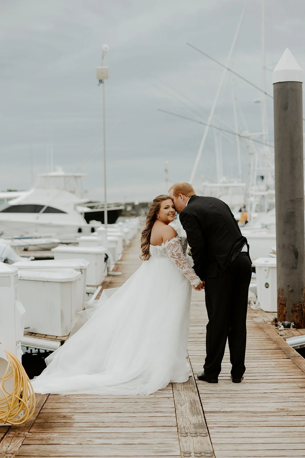 A couple taking coastal wedding photos at their new hampshire wedding venue