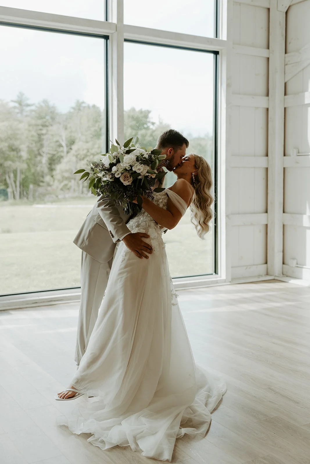 A bride and groom posing inside the greenery at mckenzies farm