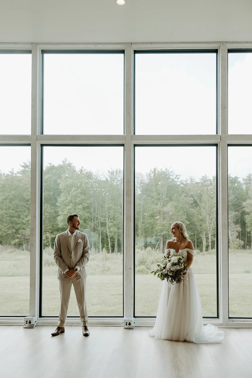 A bride and groom posing inside the greenery at mckenzies farm