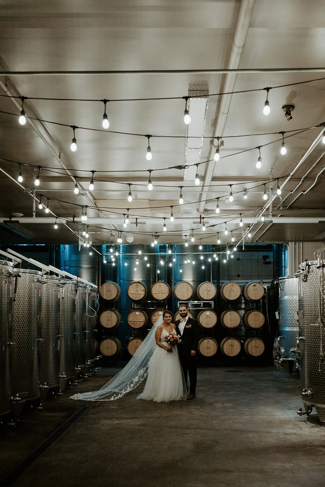 A couple taking photos at their winery new hampshire wedding venue