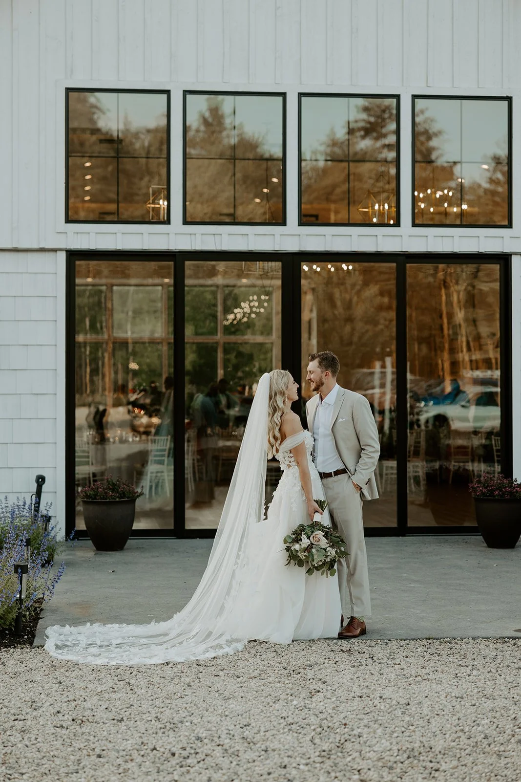 A bride and groom posing at their new hampshire wedding venue