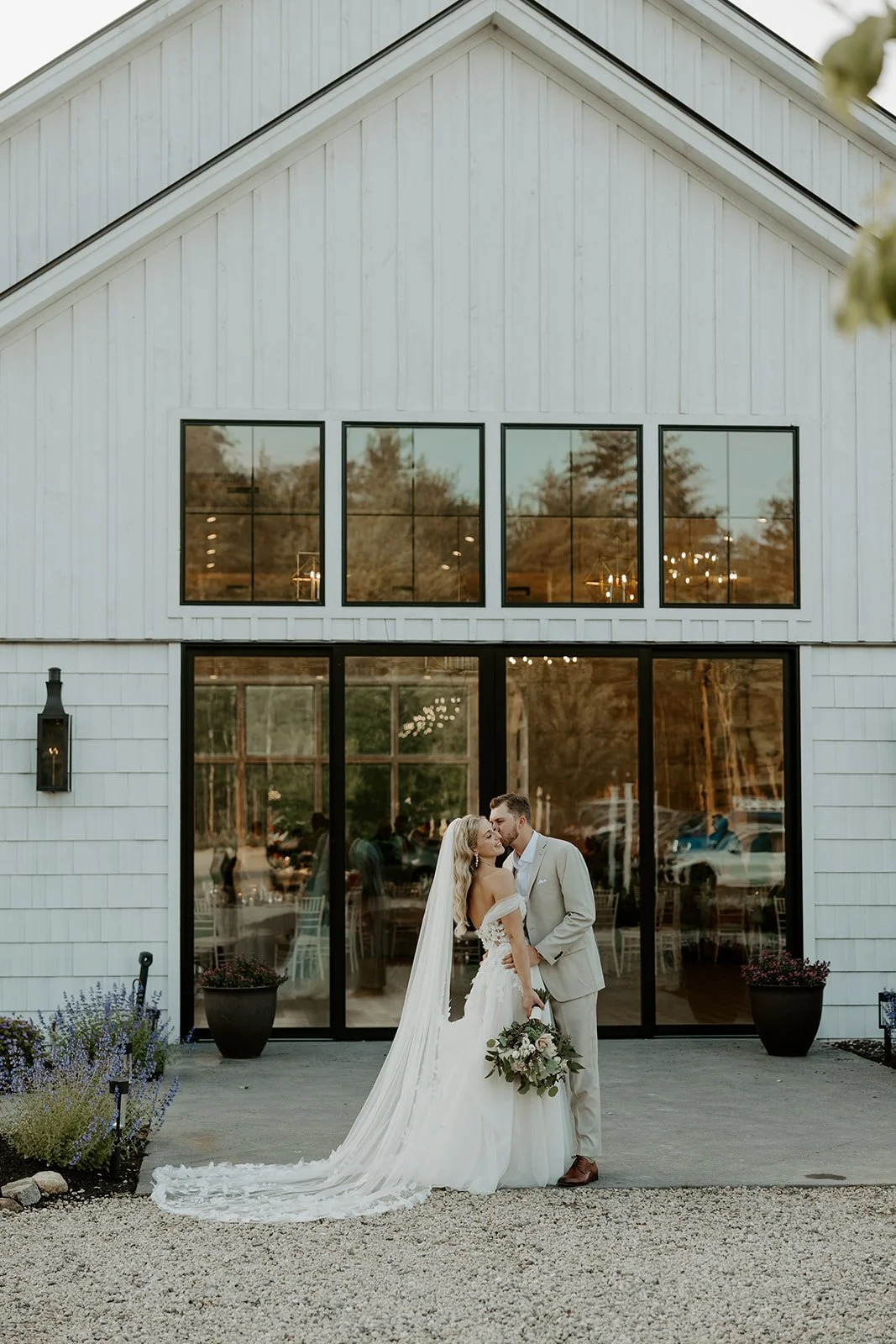 A bride and groom posing at their new hampshire wedding venue