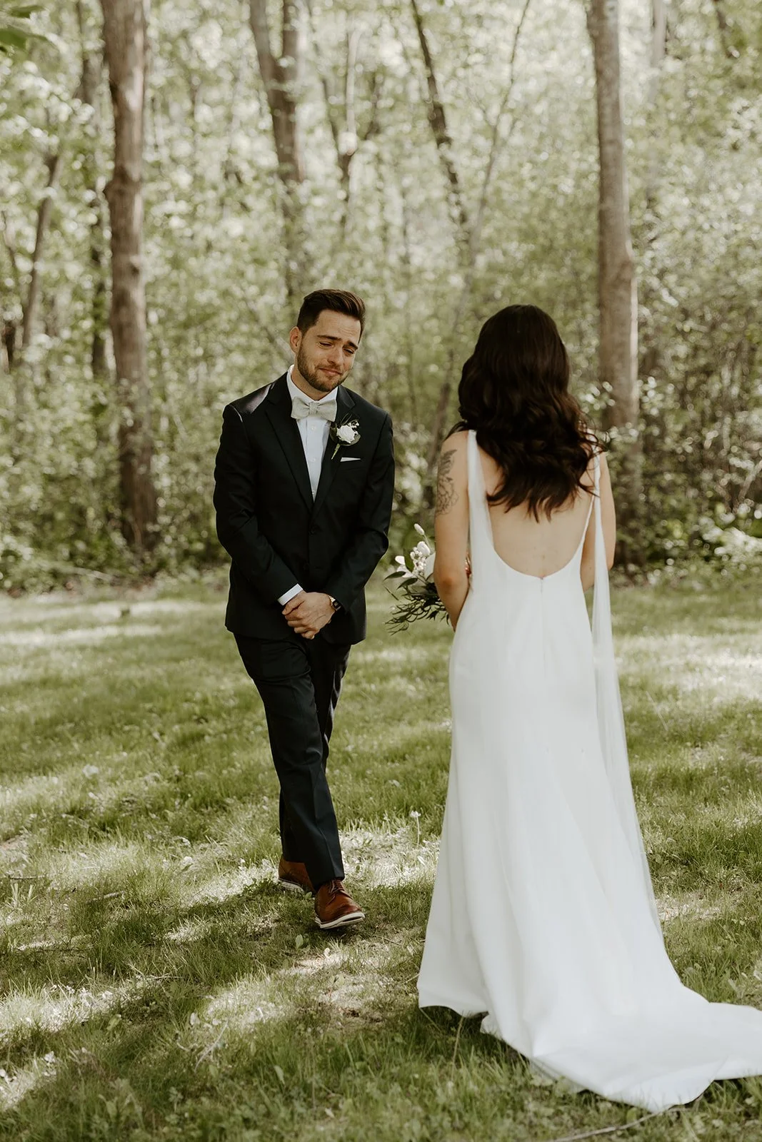 A groom's reaction to a first look with his wife