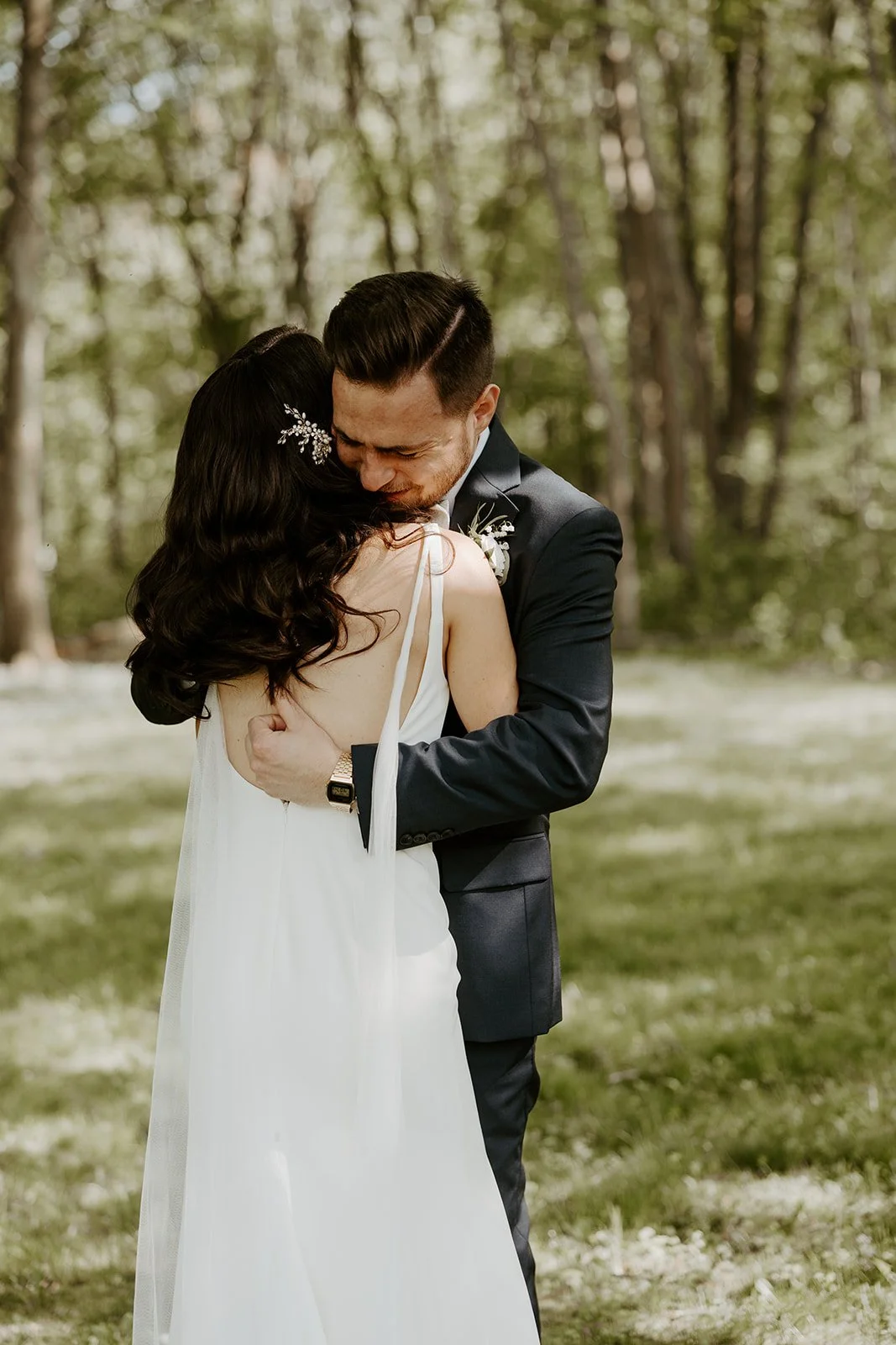 A bride and groom hugging in candid wedding photos