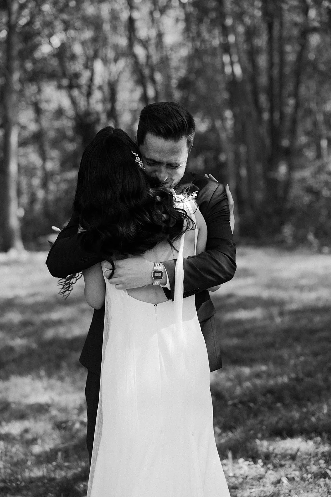 A bride and groom hugging in candid wedding photos