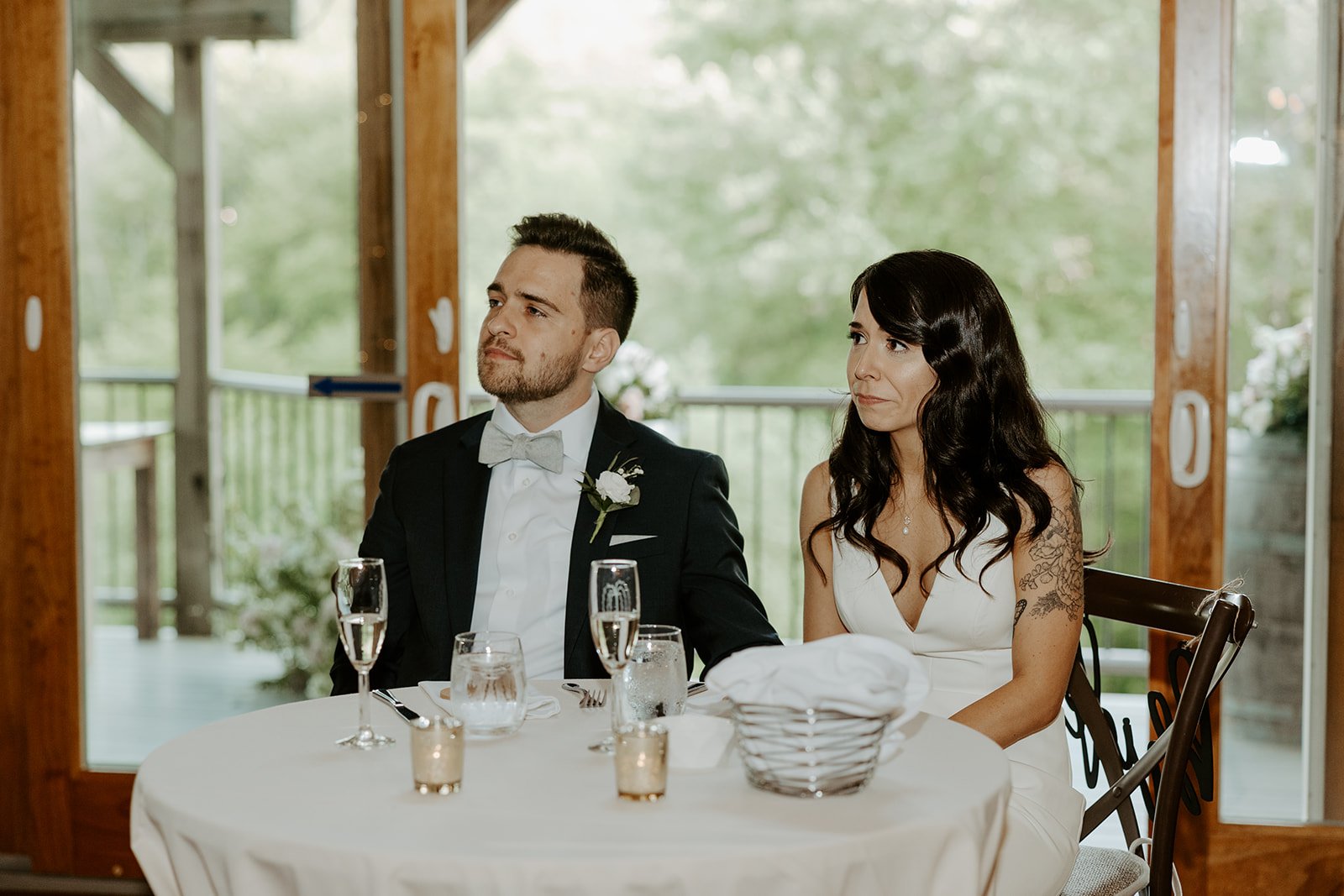 Candid wedding photos of a bride and groom during toasts