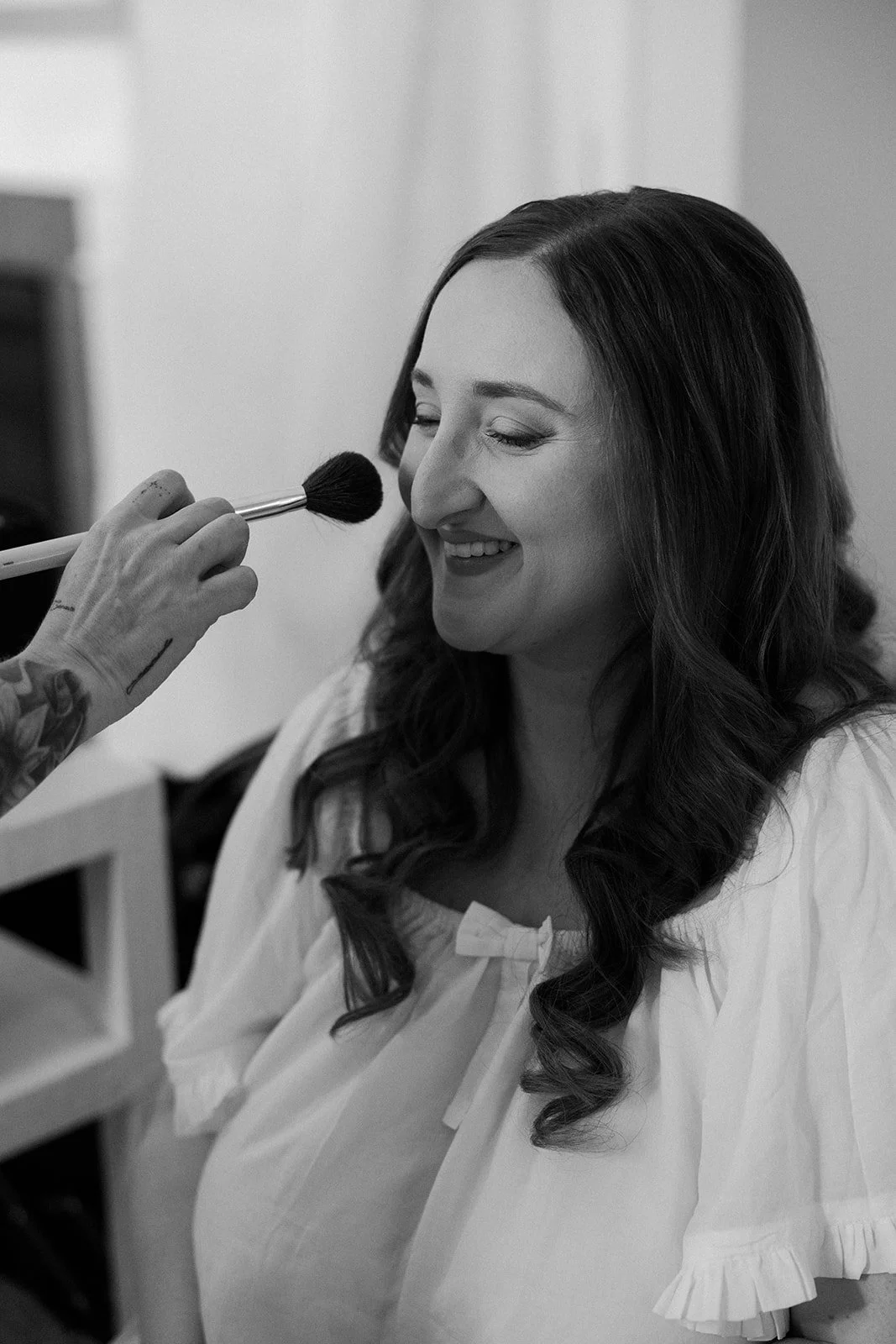 A bride having makeup applied for her wedding