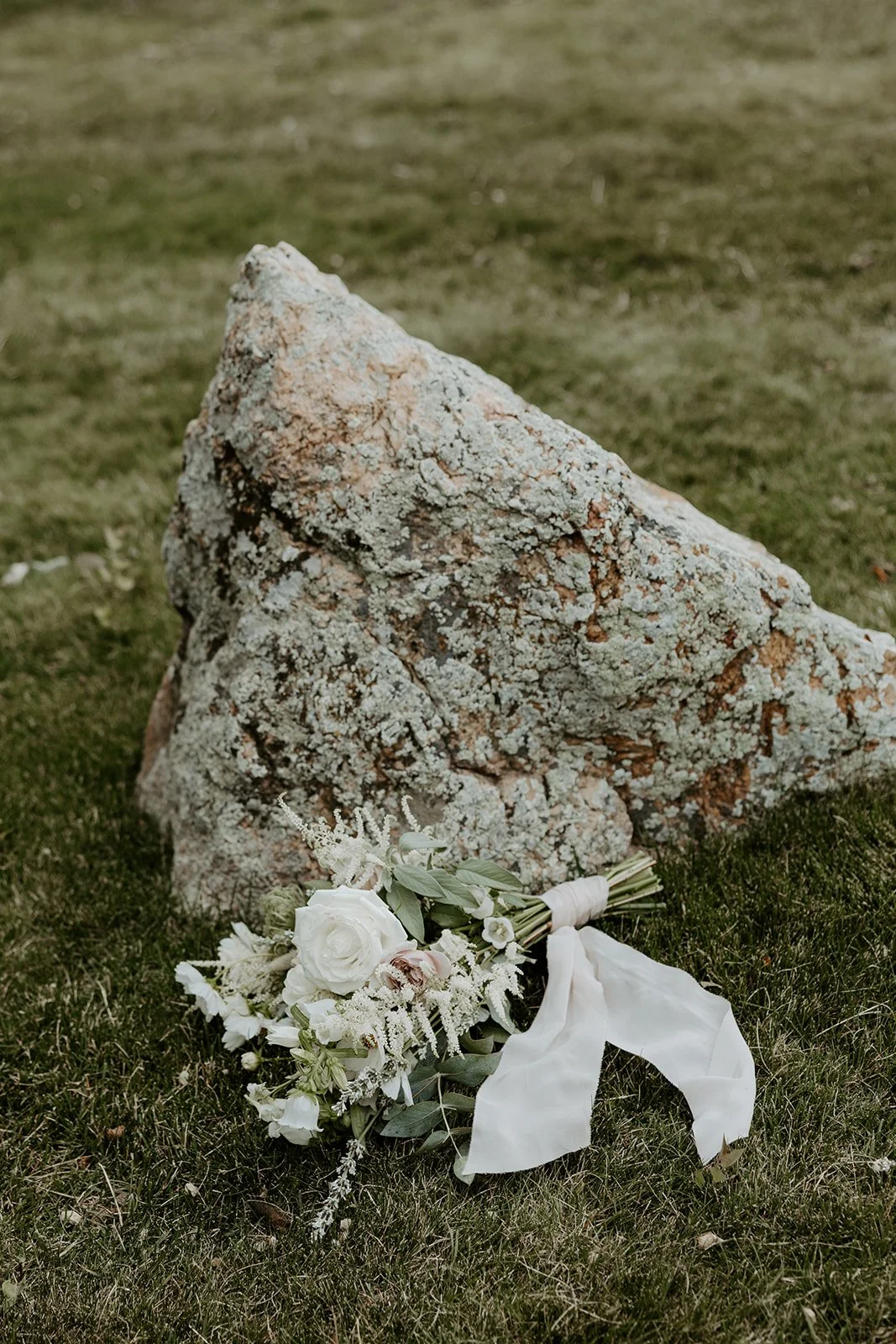 a wedding bouquet lying on the ground outside