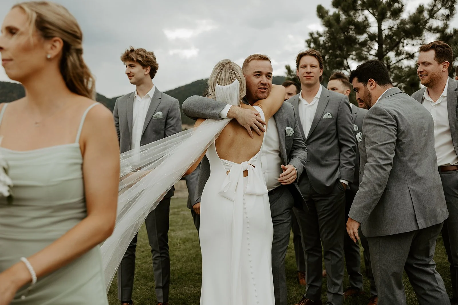 A bride hugging a groomsman