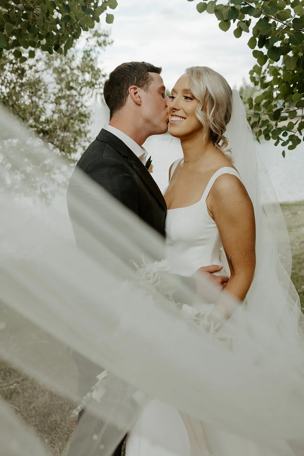 A bride and groom posing for wedding photos