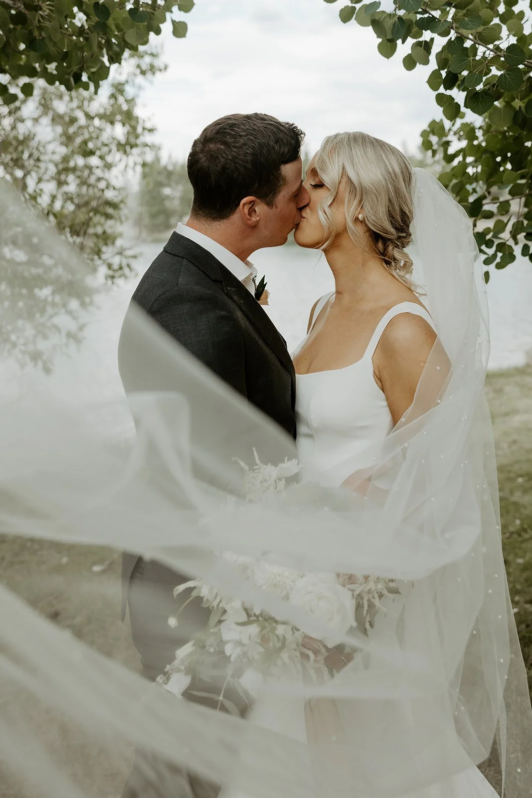 A bride and groom posing for wedding photos