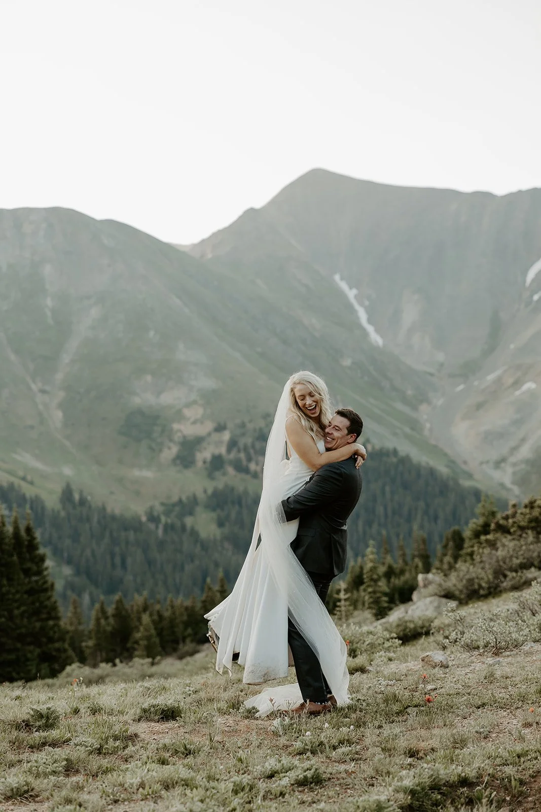 A bride and groom posing for Colorado destination wedding photos