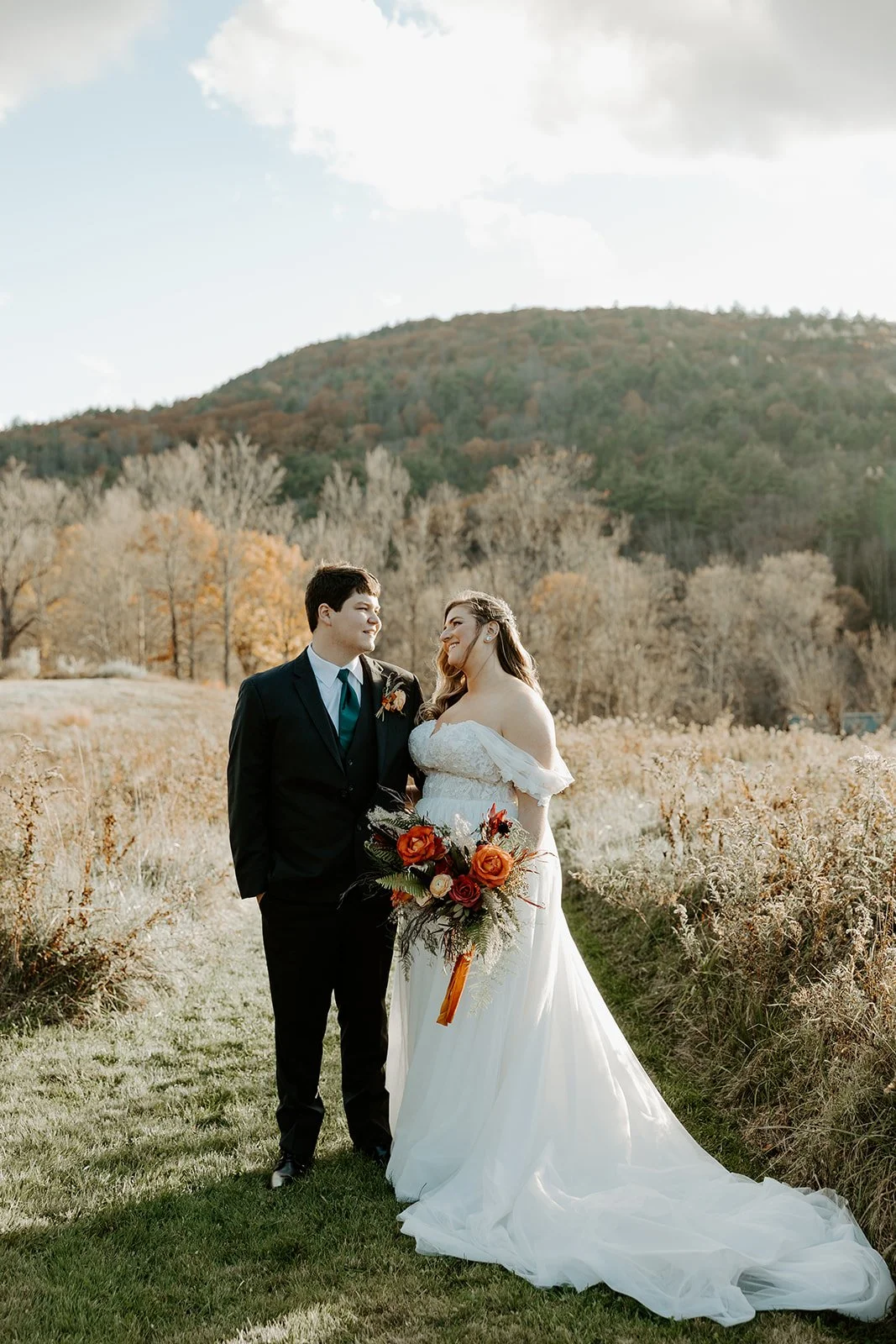 A bride and groom pausing for fall wedding photos