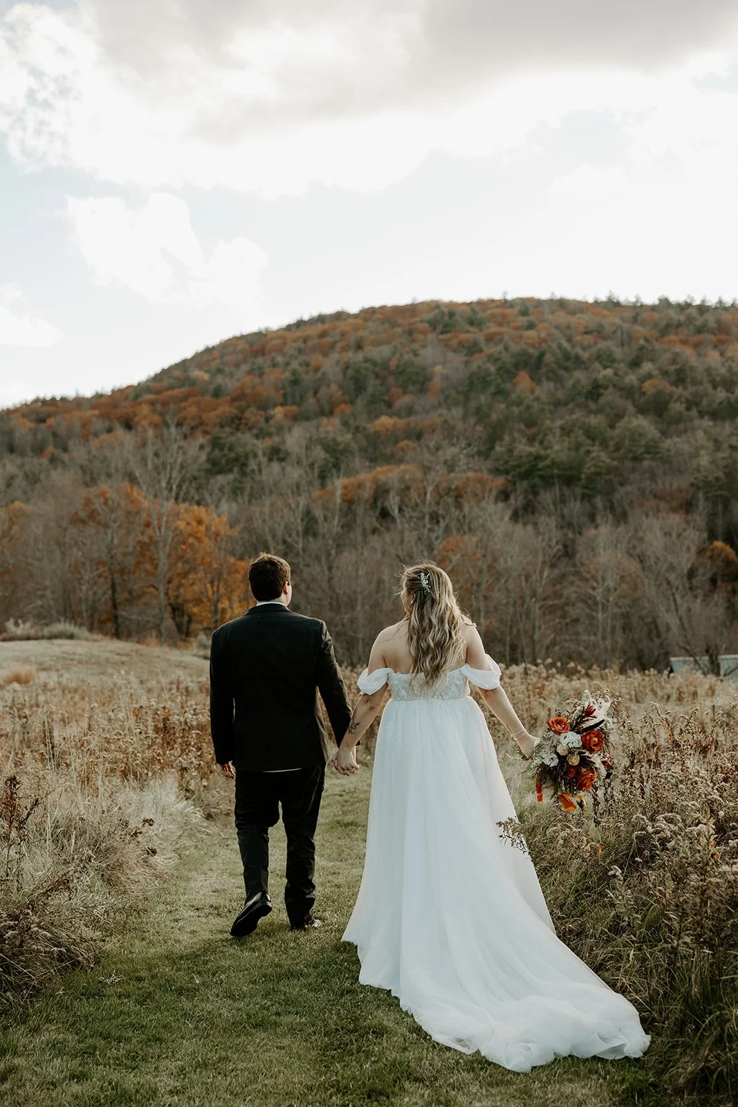 A bride and groom pausing for fall wedding photos