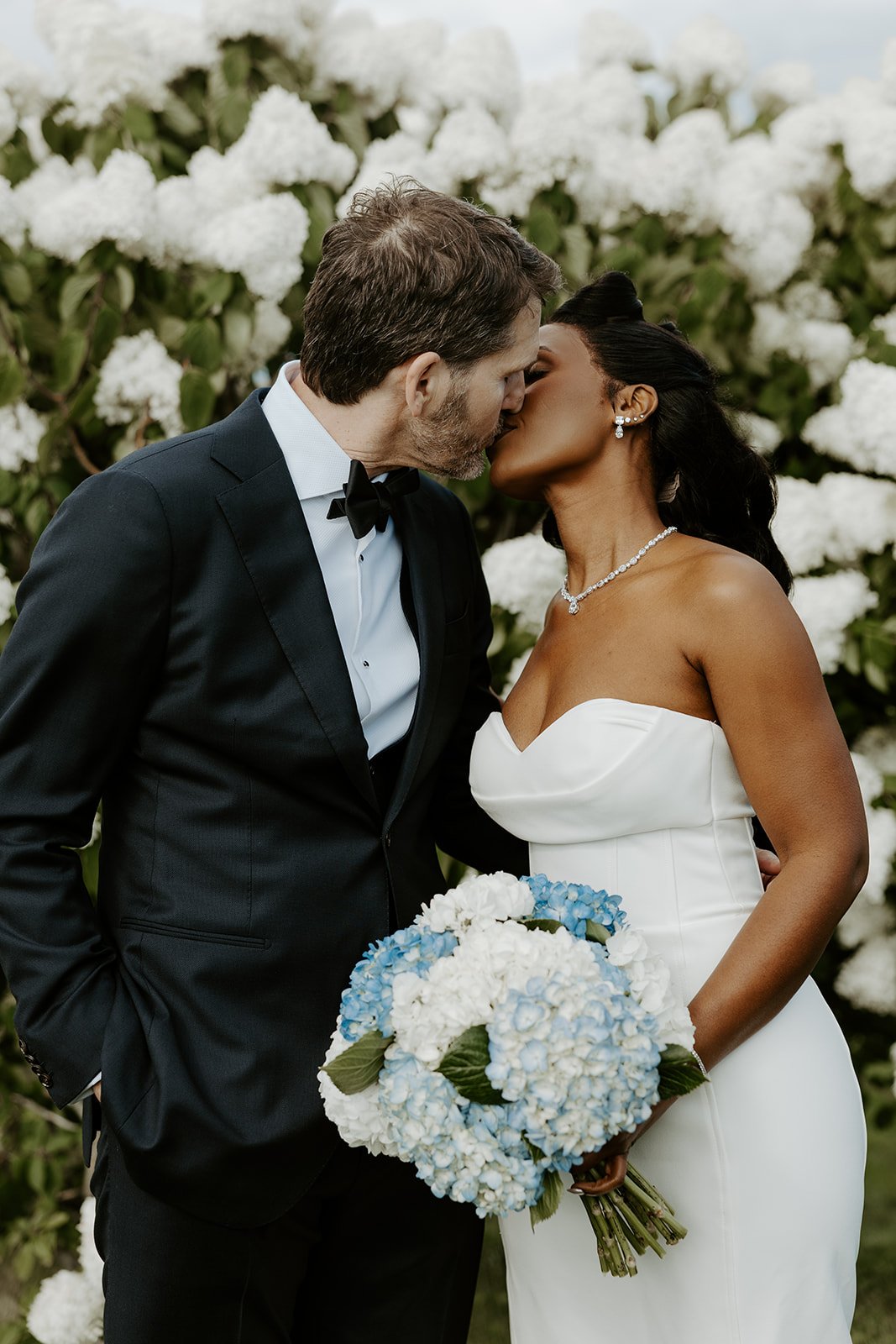 A bride and groom posing for coastal wedding photos