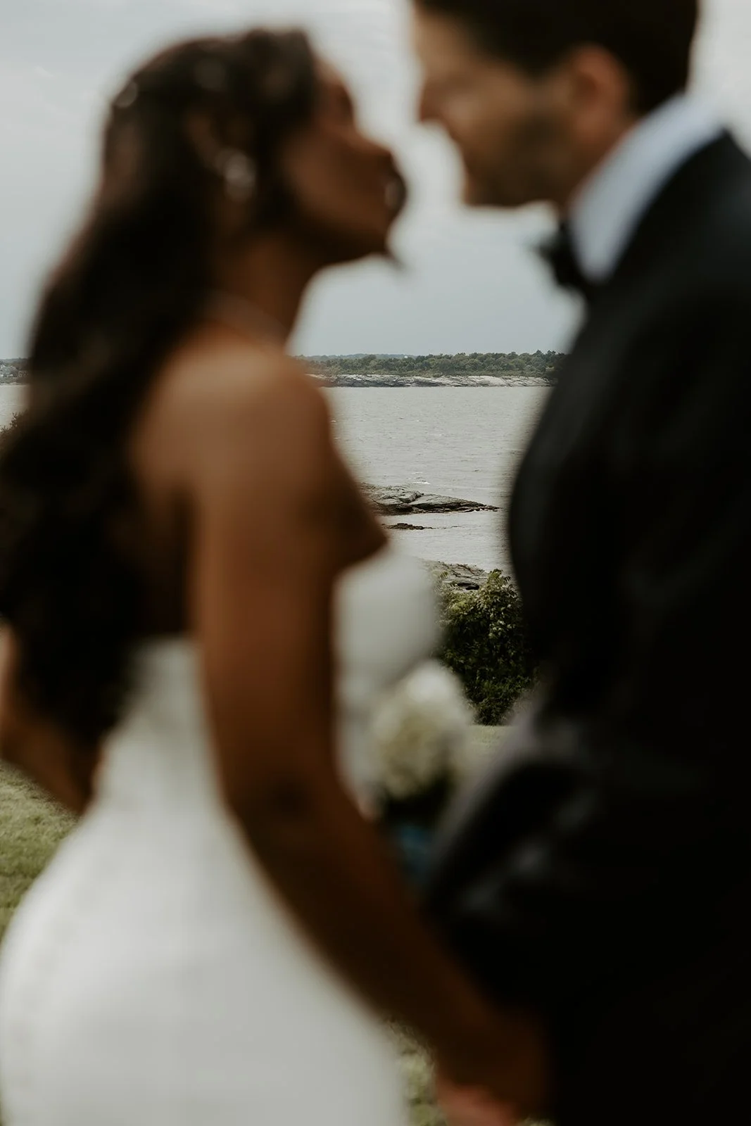 A bride and groom posing for coastal wedding photos