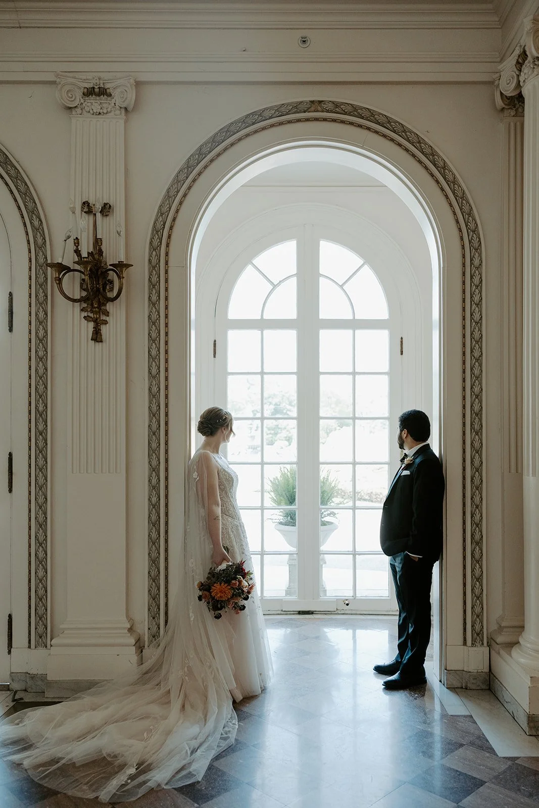 A bride and groom posing for wedding photos in their estate wedding venue