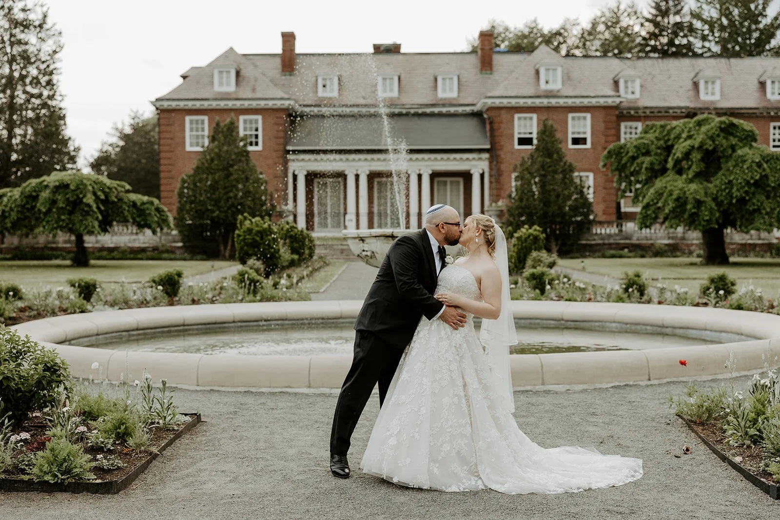 A bride and groom outside of their estate wedding venue
