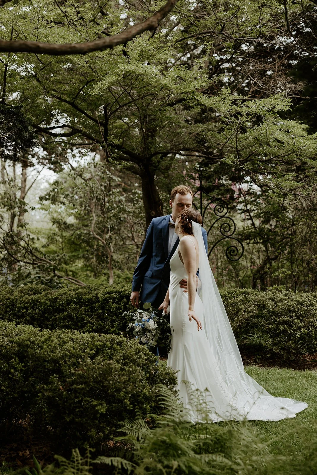 A bride and groom kissing at their estate wedding venue