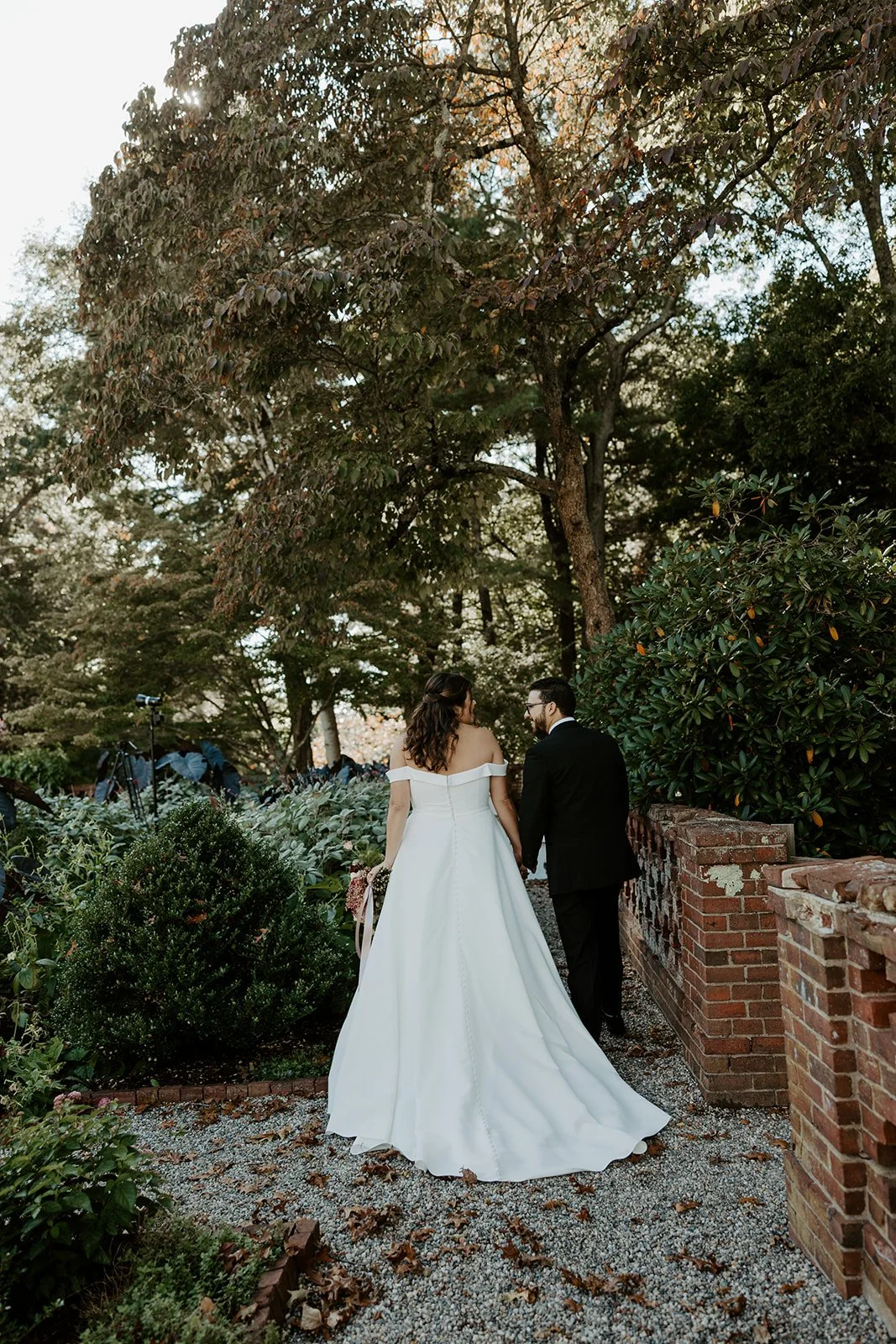 A bride and groom in the gardens at Bradley Estate