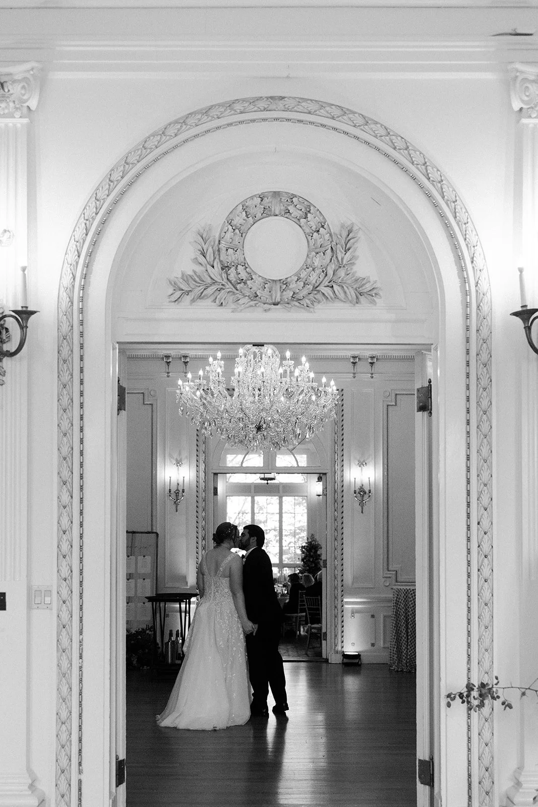A bride and groom dancing inside of an estate wedding venue