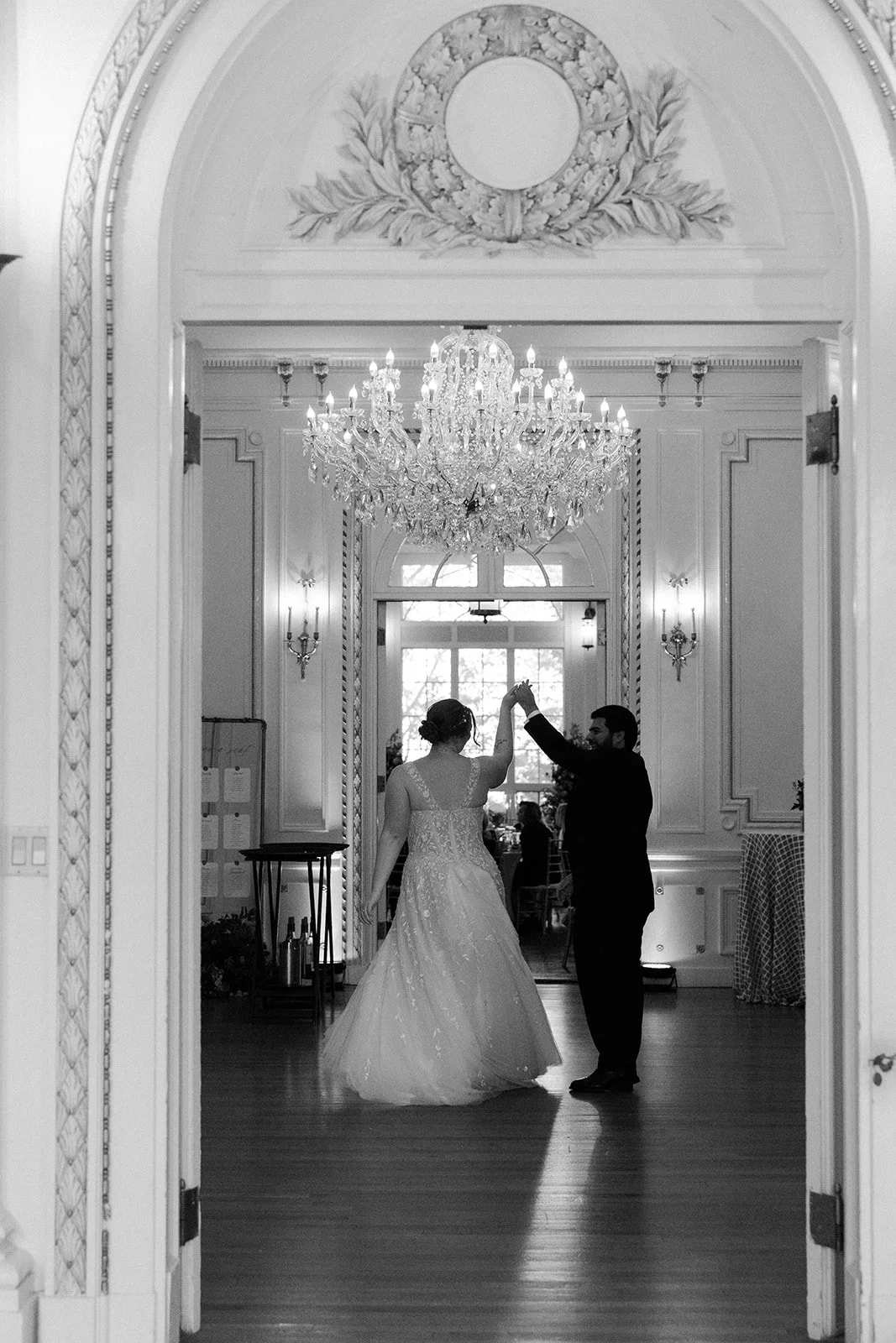A bride and groom dancing inside of an estate wedding venue