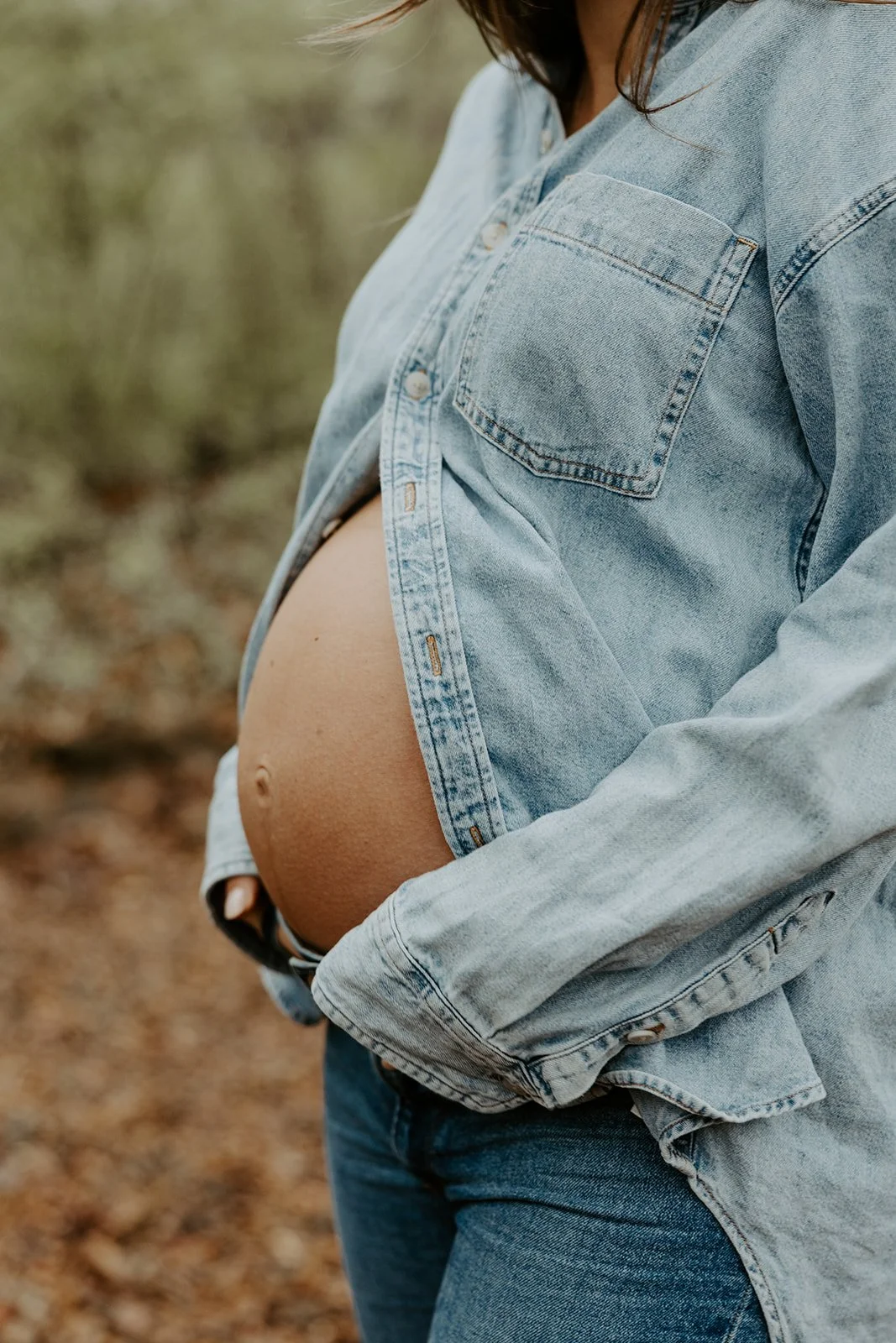 A woman's baby bump in a maternity photoshoot