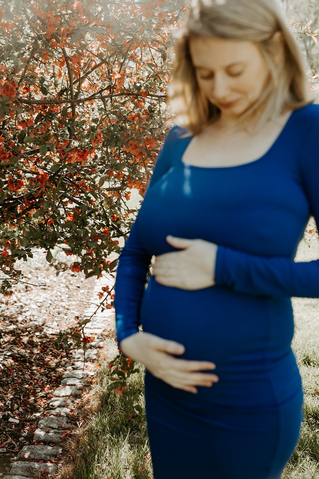 A woman holding her baby bump for maternity photos