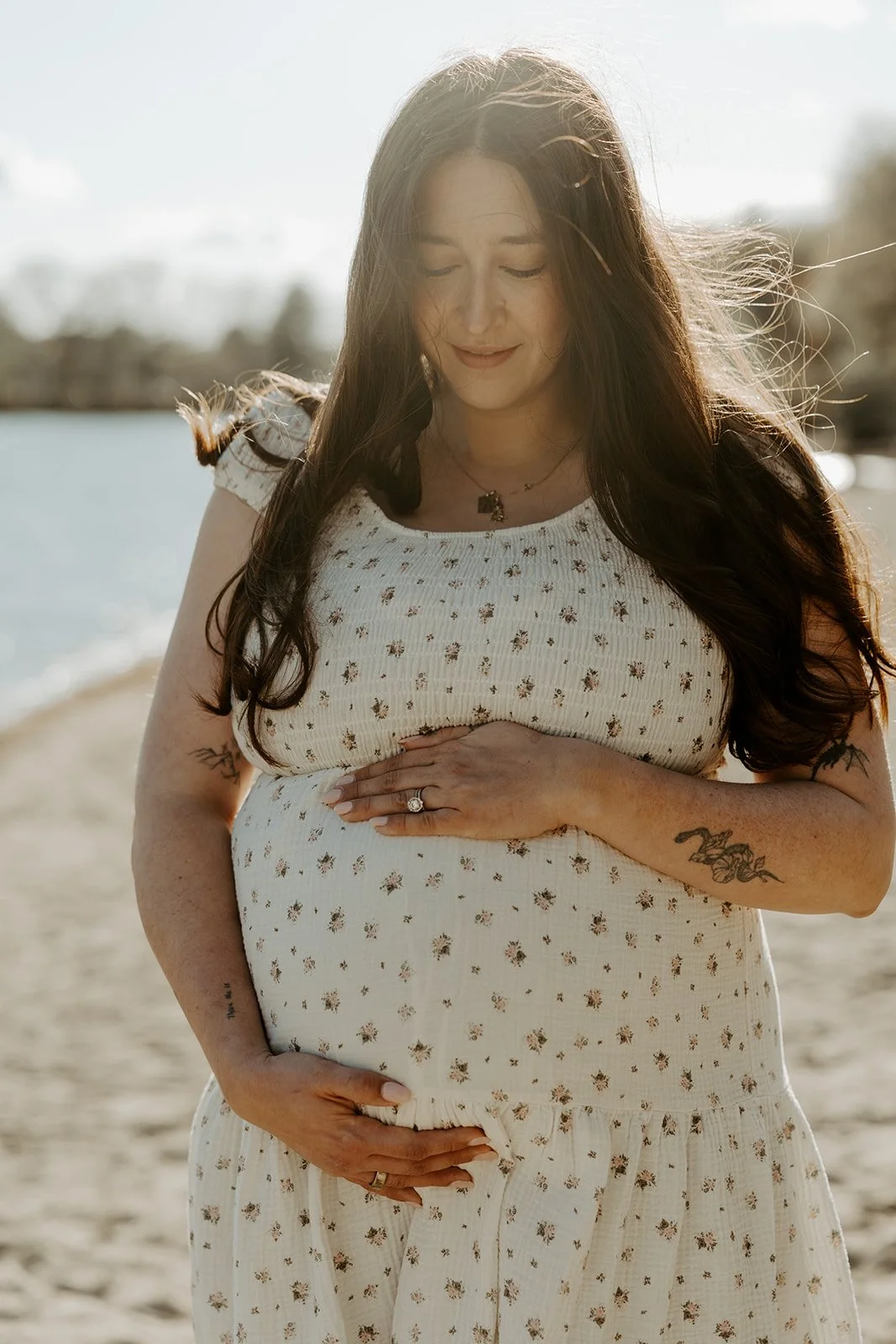 A woman in a maternity photoshoot on the beach