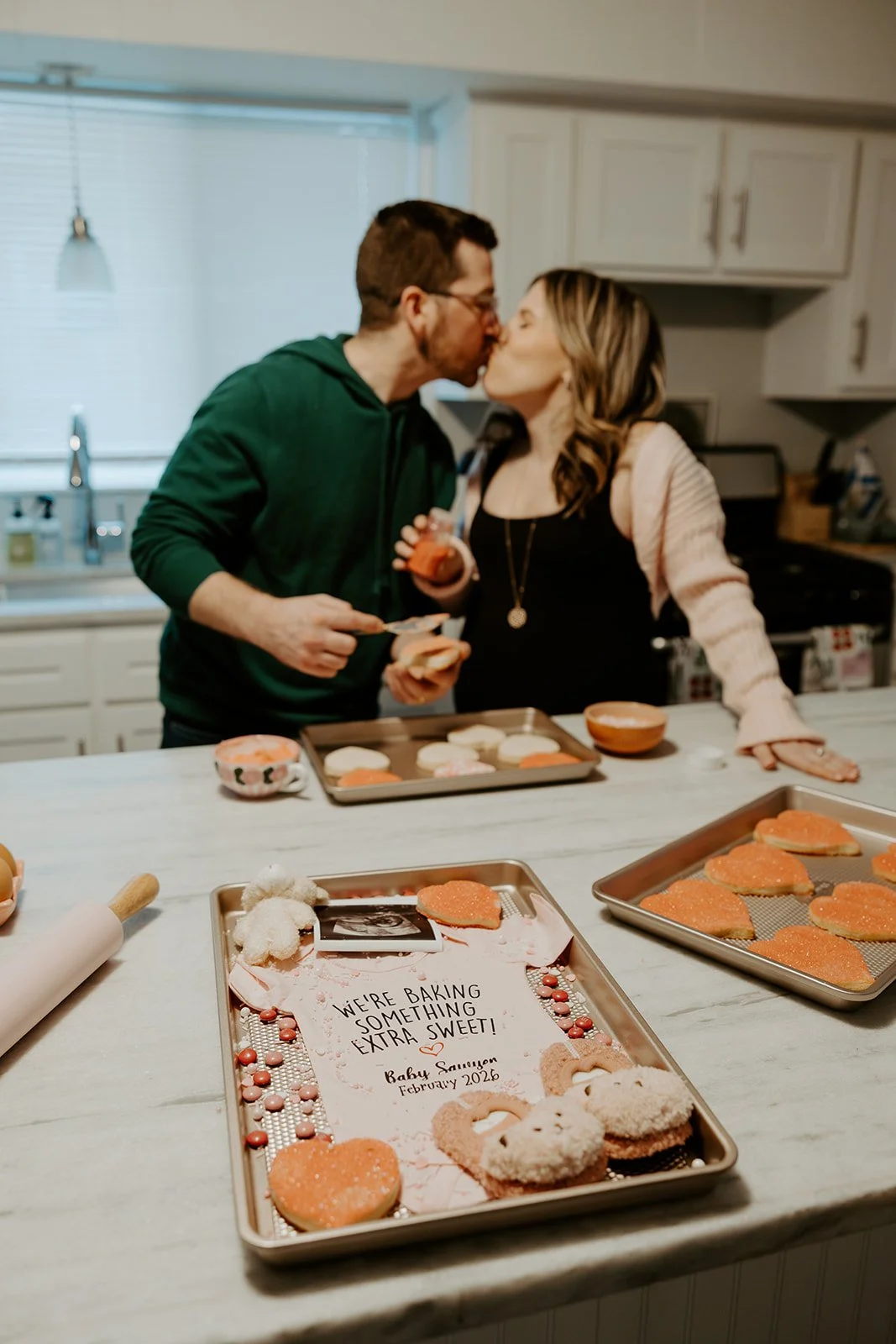 A couple kissing during at home maternity photos