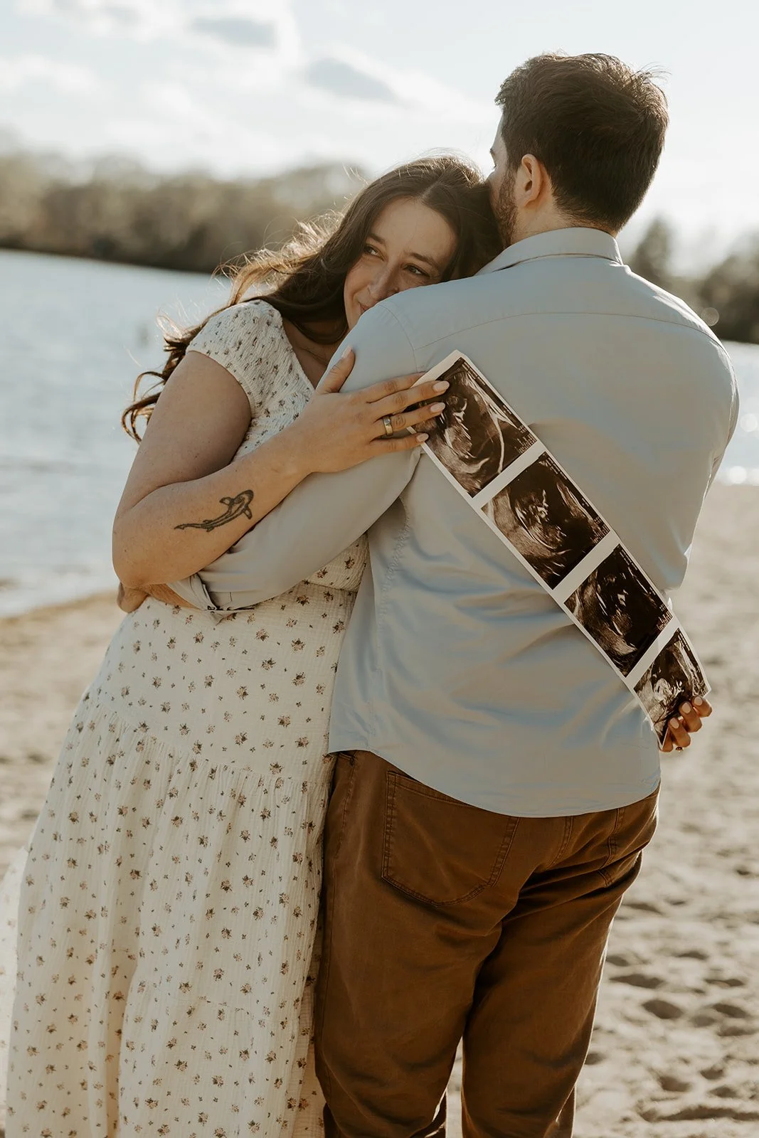 A couple hugging during maternity photos