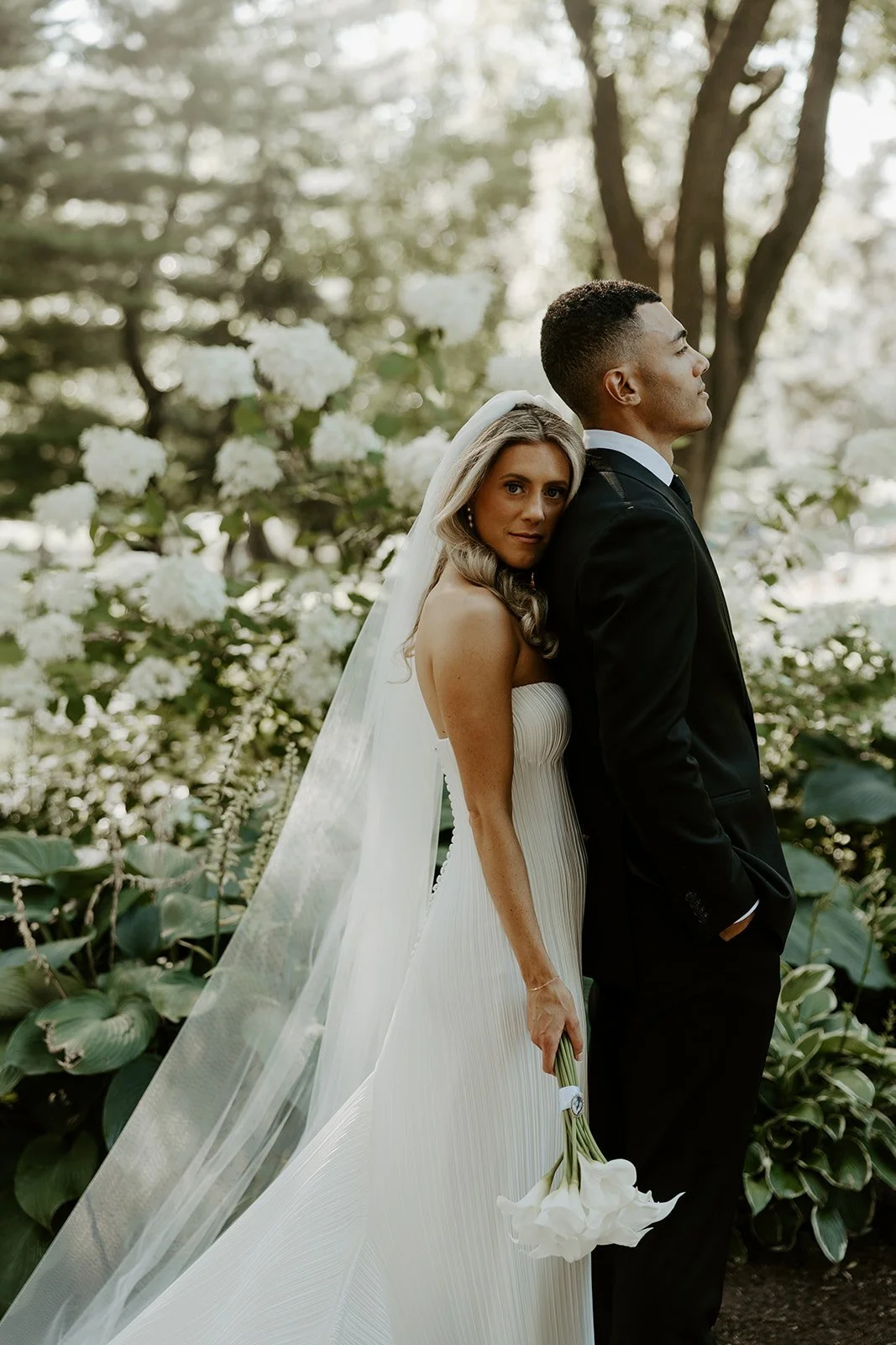 A bride and groom taking wedding photos in Boston Public Garden
