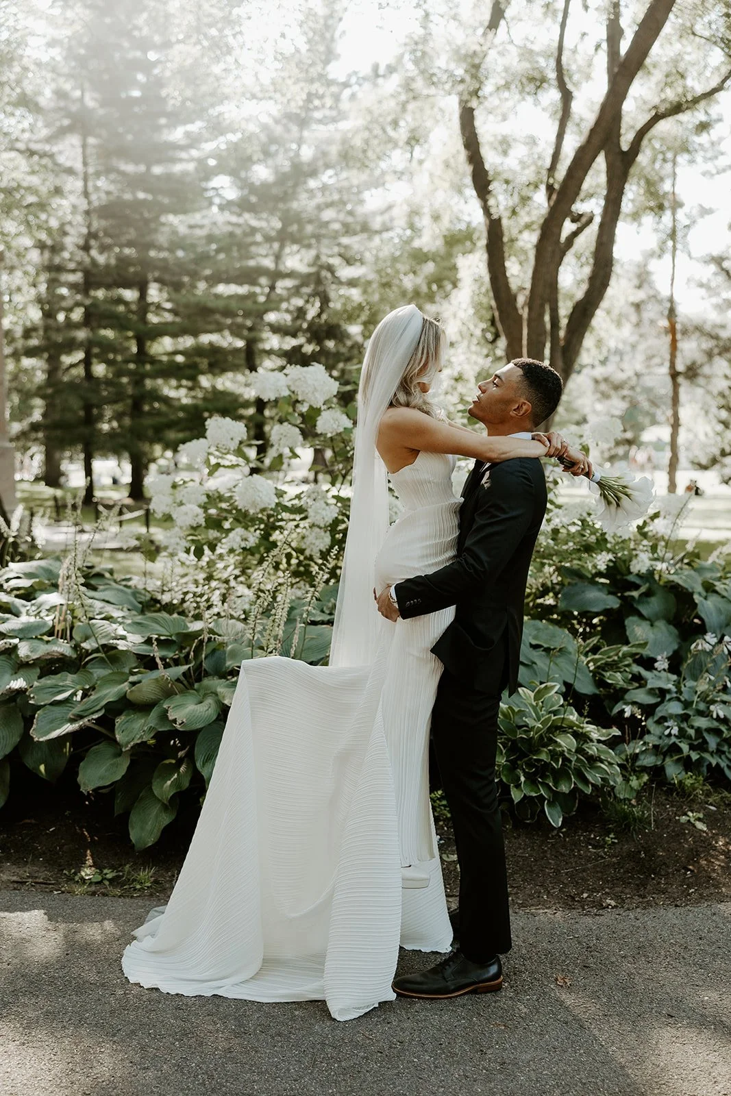 A bride and groom taking wedding photos in Boston Public Garden