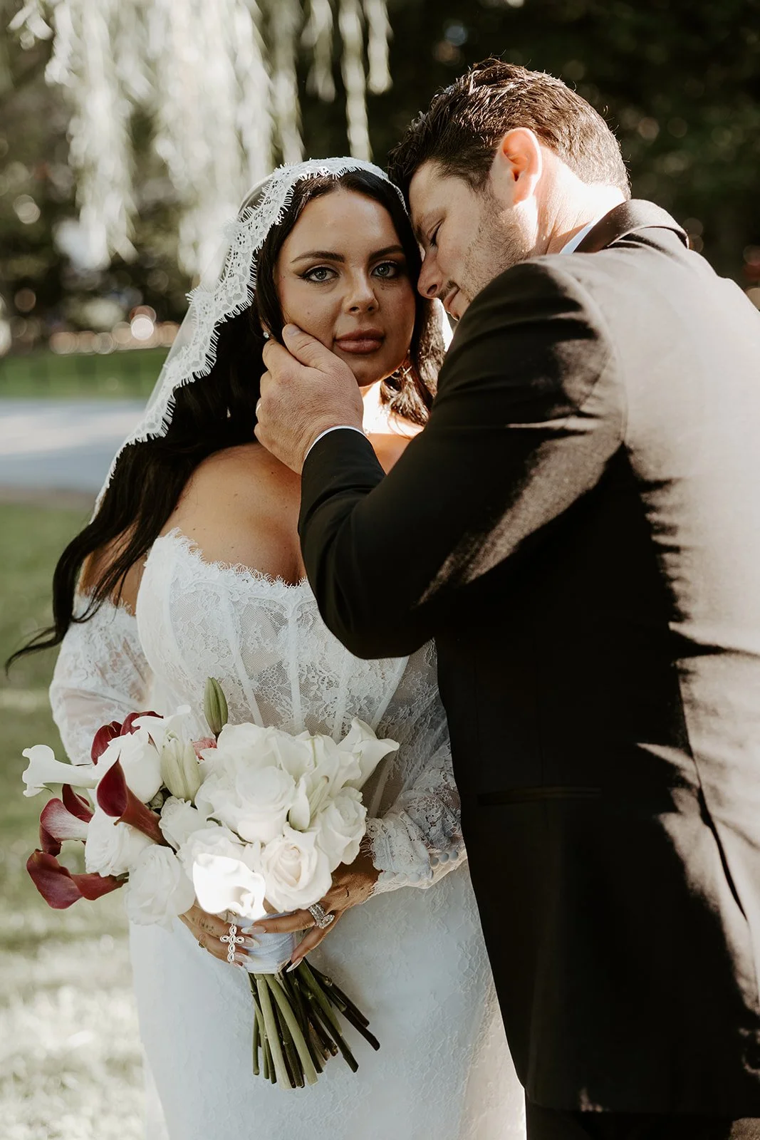 A bride and groom posing for Boston Public Garden wedding photos