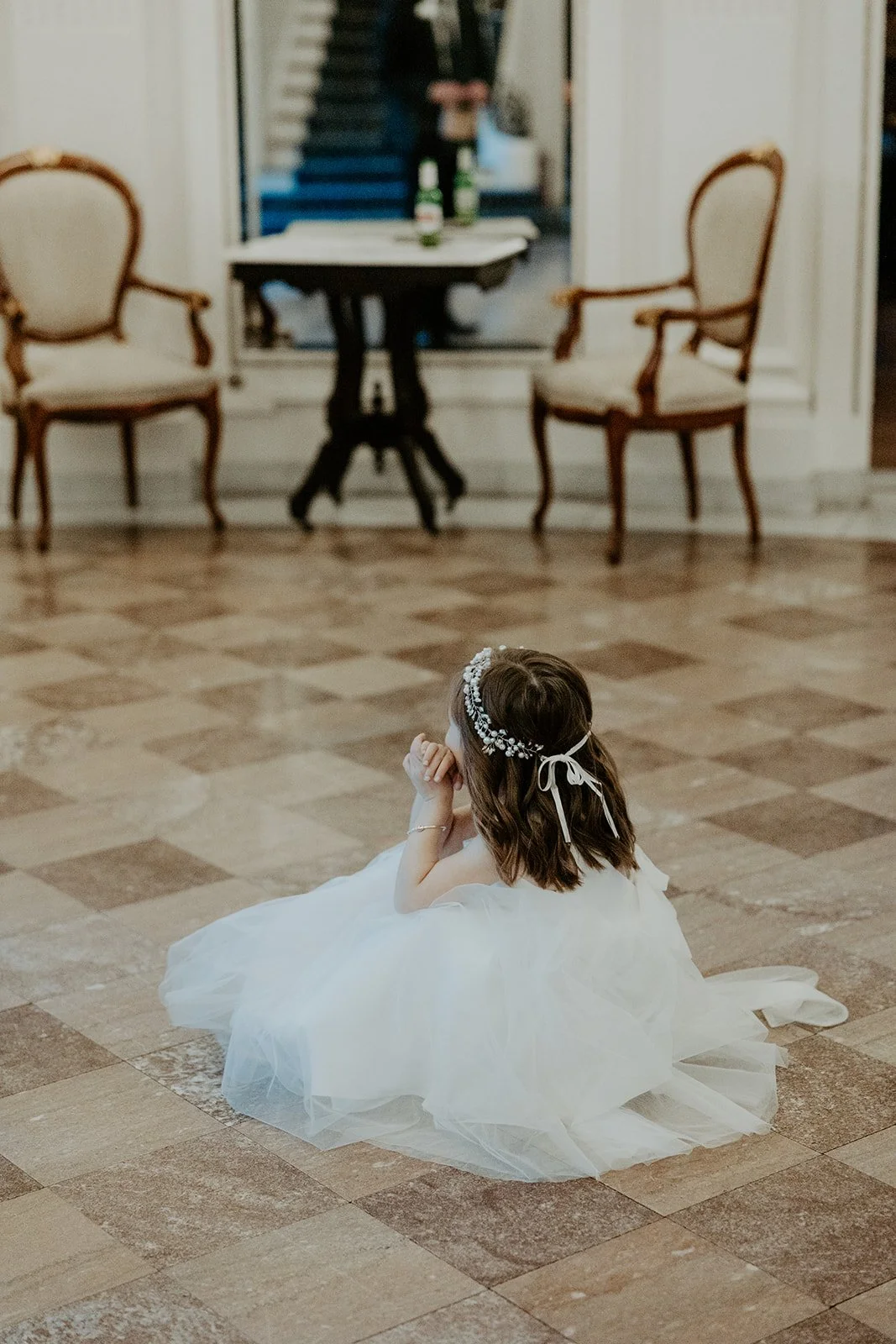 A flower girl looking at a bride in an estate wedding