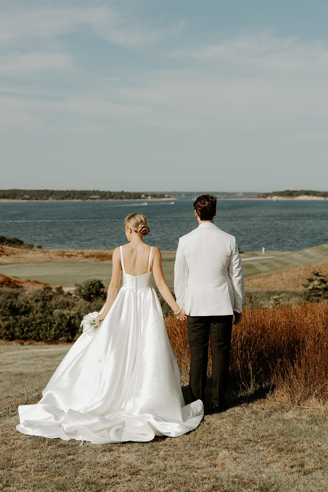 A bride and groom at their coastal wedding