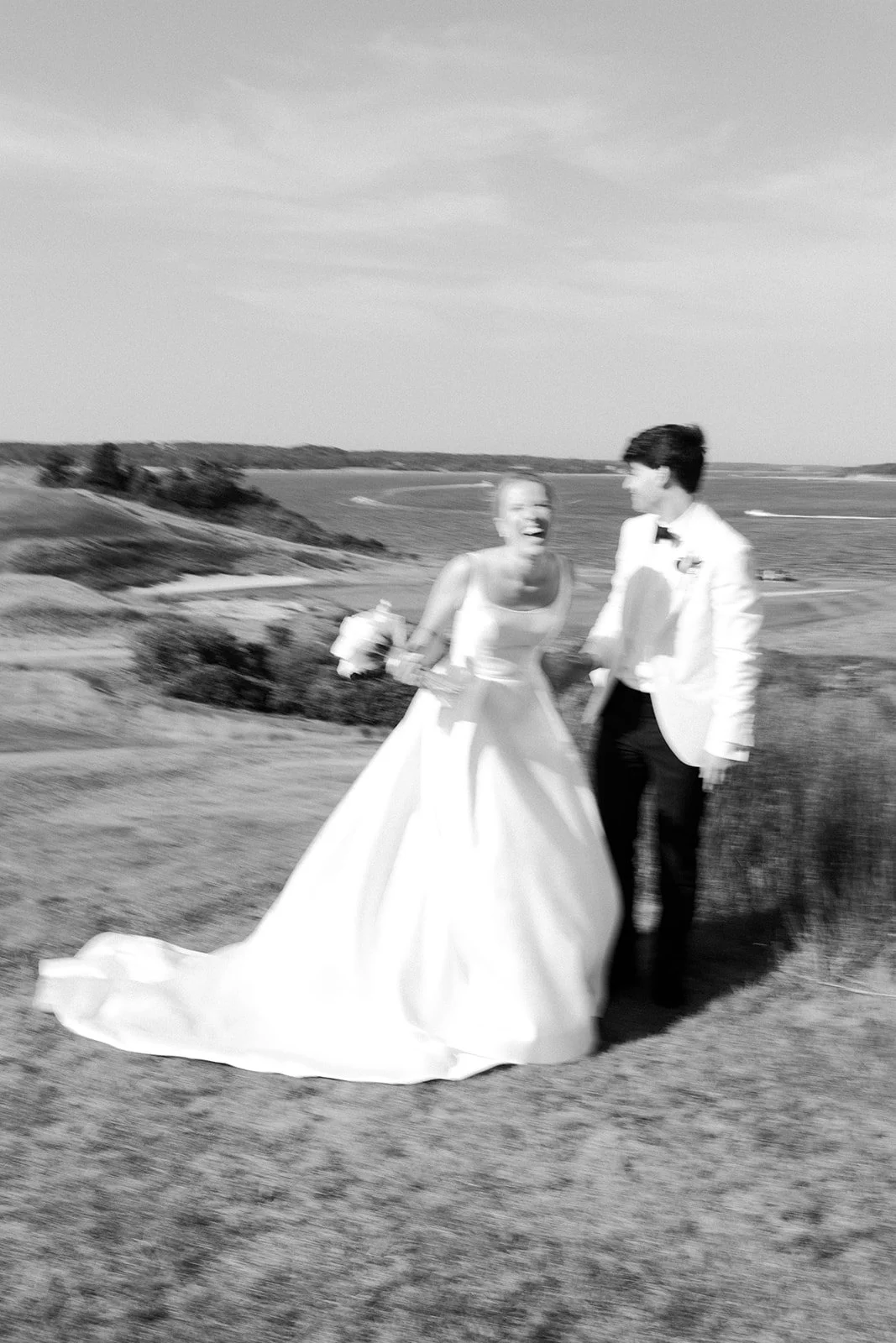 A bride and groom in blurry coastal wedding photos