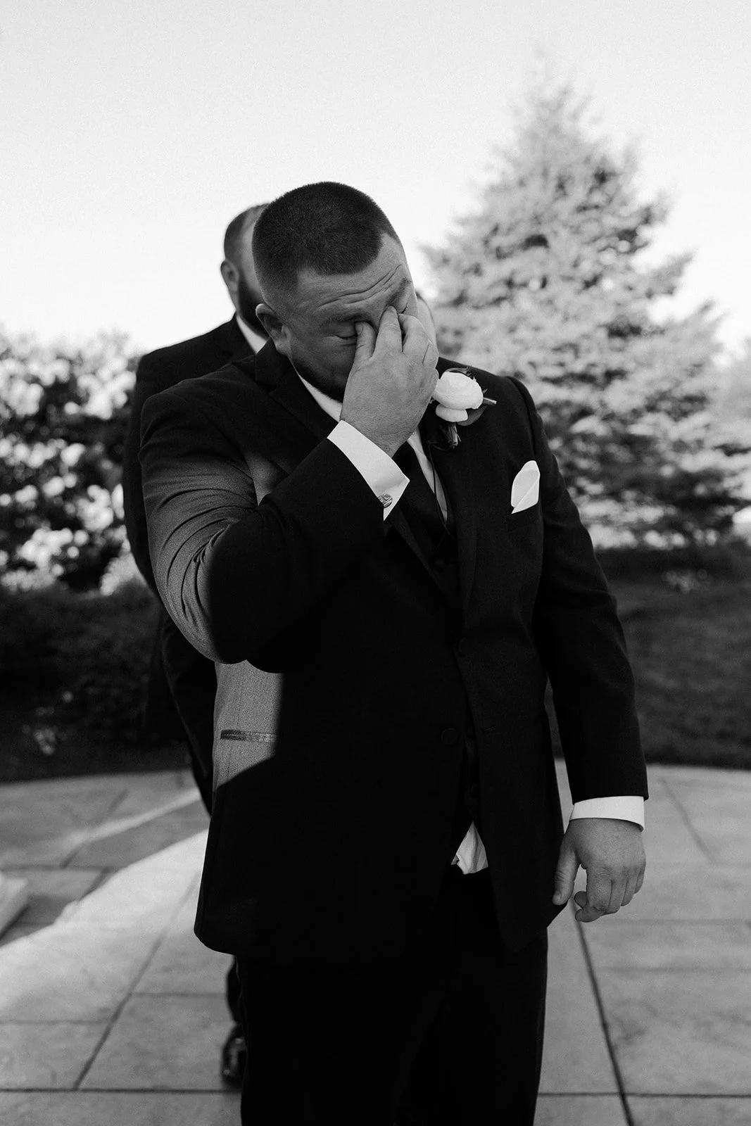 A groom crying in candid wedding photos