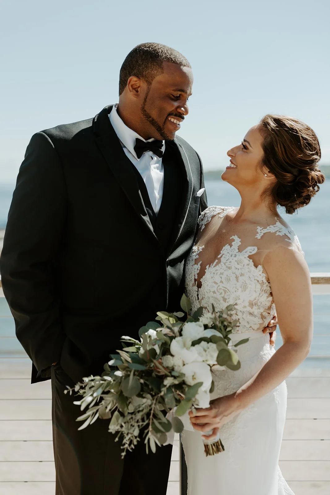 A bride and groom posing for photos at their Beauport Hotel wedding
