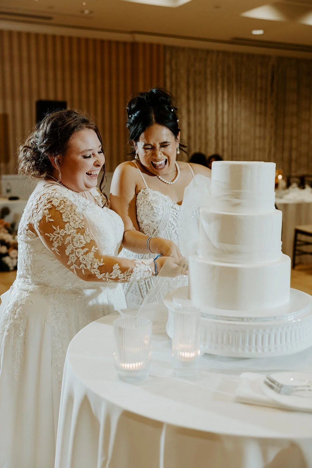Brides cutting their wedding cake