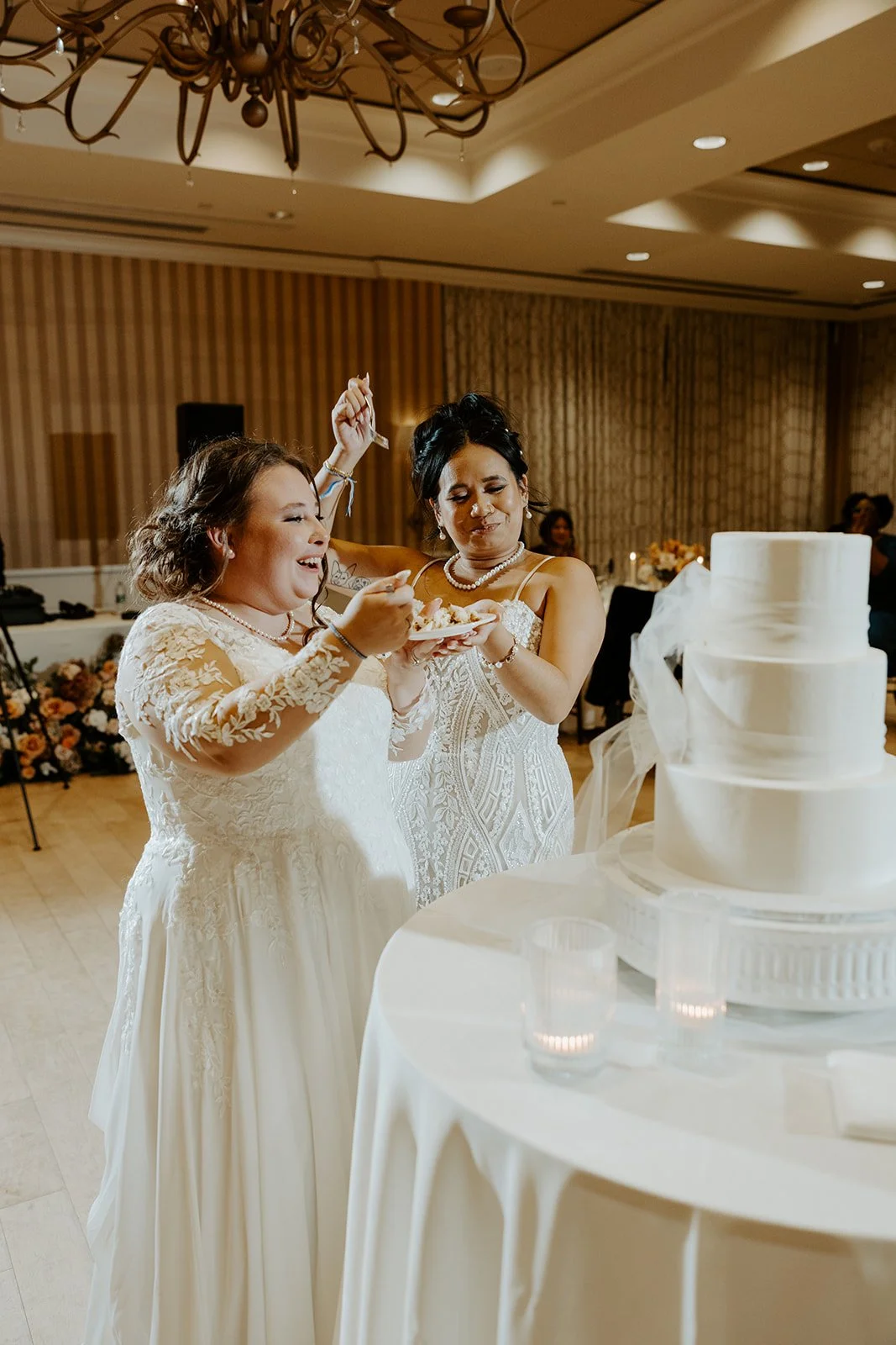Brides cutting their wedding cake