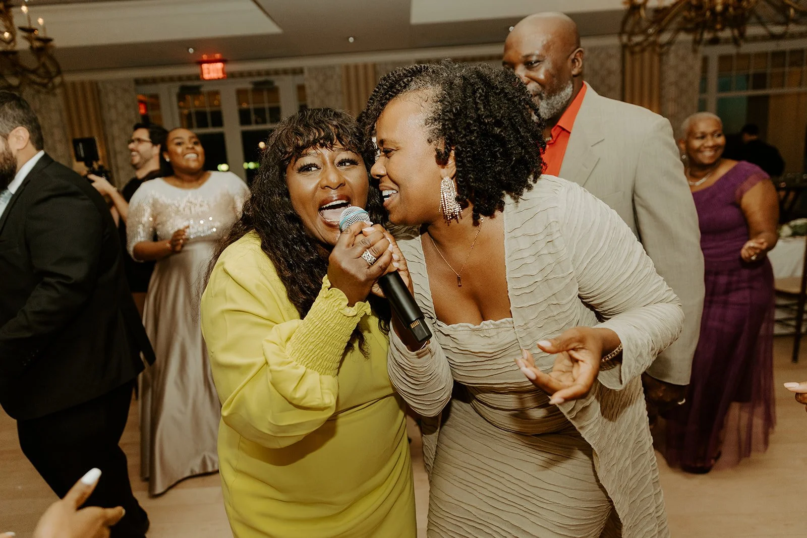 Wedding guests singing at a wedding reception